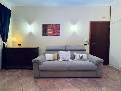a living room with a couch with pillows on it at Via Arese Apartment in Rome