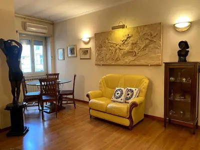 a living room with a yellow couch and a table at Home Luxury Emy in Rome