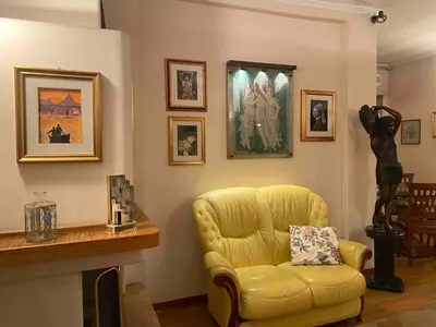 a living room with a yellow chair and a fireplace at Home Luxury Emy in Rome