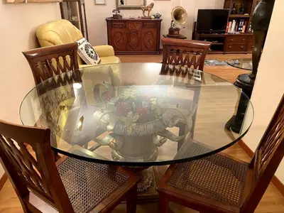 a glass dining room table with a vase of flowers at Home Luxury Emy in Rome