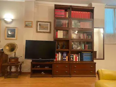 a living room with a large entertainment center with a television at Home Luxury Emy in Rome