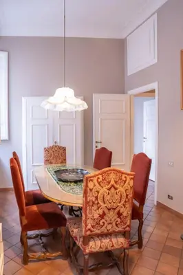 a kitchen and dining room with a table and chairs at Home d'Elite Ripetta - Spanish Steps in Rome