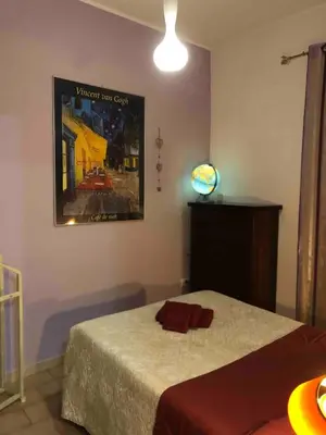 a bedroom with a bed and a poster on the wall at Appartamento a due passi dalla Storia e dalla Movida Romana in Rome