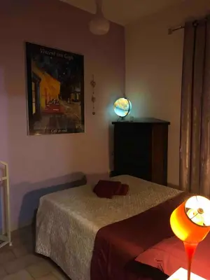 a bedroom with a bed and a lamp on a table at Appartamento a due passi dalla Storia e dalla Movida Romana in Rome