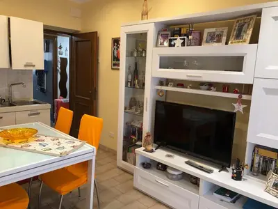 a living room with a large television in a white entertainment center at Appartamento a due passi dalla Storia e dalla Movida Romana in Rome