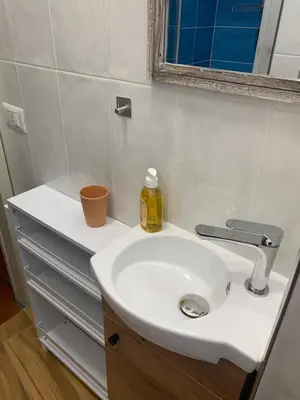 a bathroom with a white sink and a mirror at Gelsomino a San Pietro in Rome
