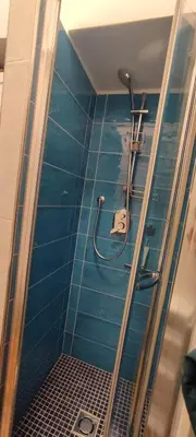 a bathroom with a shower with blue tiles at Gelsomino a San Pietro in Rome