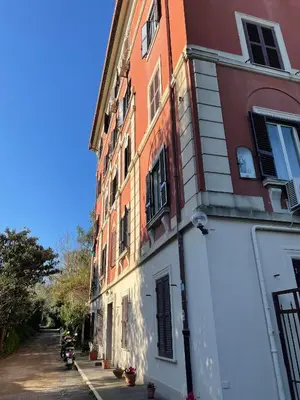 a red and white building with a motorcycle parked next to it at Gelsomino a San Pietro in Rome
