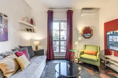 a living room with a couch and a chair and a television at AwesHomeItaly - Spagna Glamour Life Penthouse in Rome
