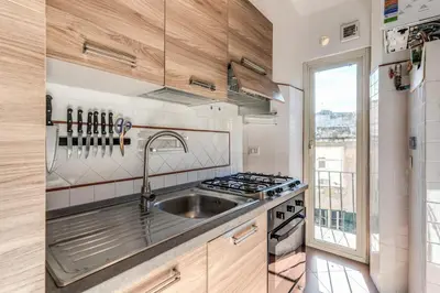 a kitchen with a sink and a stove at AwesHomeItaly - Spagna Glamour Life Penthouse in Rome