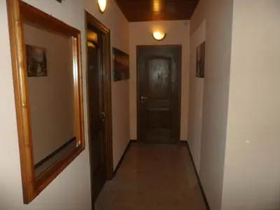 a hallway with a black door and a tile floor at Gina B&B in Rome