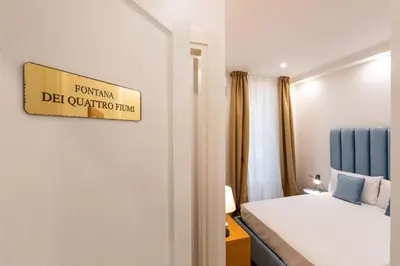 a hotel room with a bed and a mirror at Affresco LR Collection in Rome