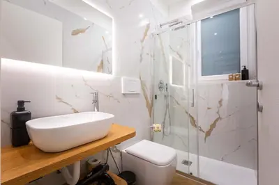 a white bathroom with a sink and a toilet at Affresco LR Collection in Rome