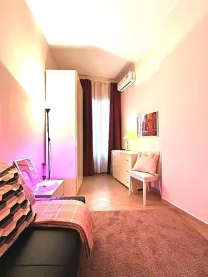 a bedroom with a bed and a desk with a laptop at Ostiense - San Paolo Garbatella - Università Roma 3 in Rome