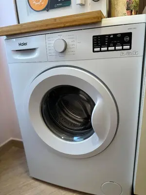 a white washing machine sitting in a kitchen at Ostiense - San Paolo Garbatella - Università Roma 3 in Rome