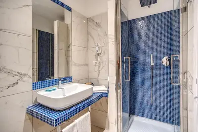 a bathroom with a sink and a shower at Piazza di Spagna Comfort Rooms in Rome