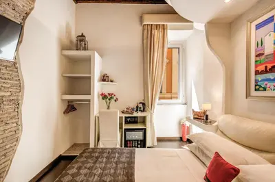a small room with a bed and a couch at Piazza di Spagna Comfort Rooms in Rome