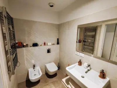 a white bathroom with a sink and a toilet at Ancient Rome Studio in Rome