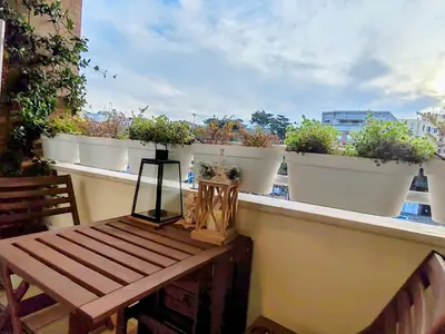 a balcony with potted plants and a wooden bench at Ancient Rome Studio in Rome