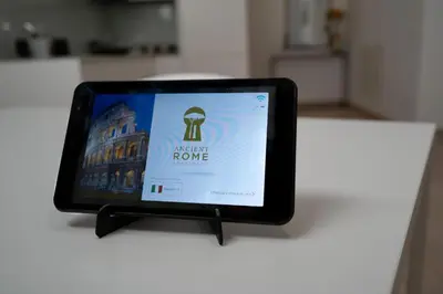 a tablet sitting on a table with a sign on it at Ancient Rome Studio in Rome