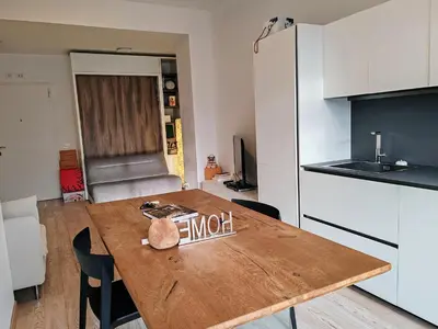 a kitchen with a wooden table in a room at Ancient Rome Studio in Rome