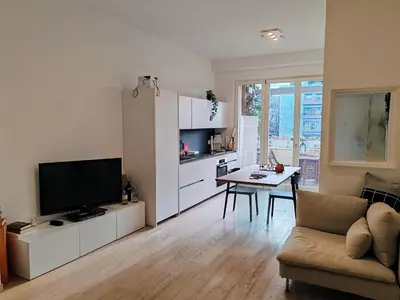 a living room with a couch and a tv and a table at Ancient Rome Studio in Rome