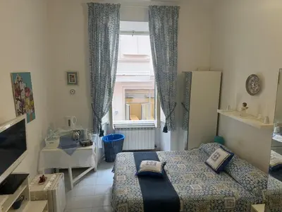 a small bedroom with a bed and a window at SweetHome Lisa in Rome