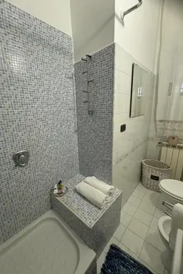 a bathroom with a shower and a tub and a toilet at SweetHome Lisa in Rome