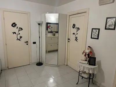 a room with a hallway with a mirror and a table at SweetHome Lisa in Rome