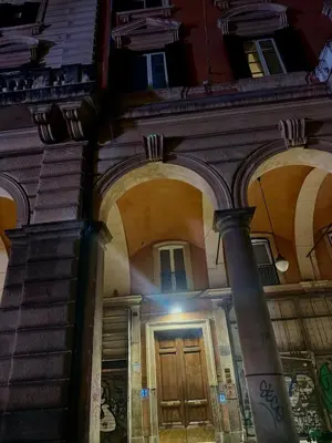 a building with a wooden door and a column at SweetHome Lisa in Rome