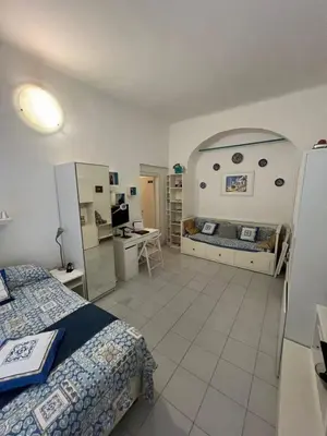 a bedroom with a bed and a desk in it at SweetHome Lisa in Rome