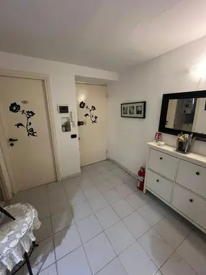 a living room with a television and a white floor at SweetHome Lisa in Rome
