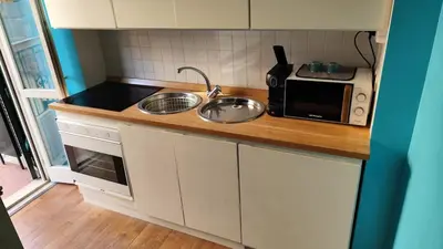 a small kitchen with a sink and a microwave at Appartamento esclusivo Casalino Vatican Suite in Rome