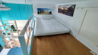 a small room with a bed and a staircase at Appartamento esclusivo Casalino Vatican Suite in Rome
