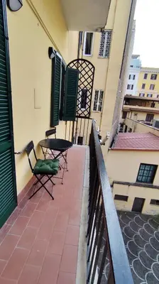 a balcony with a table and chairs on a building at Appartamento esclusivo Casalino Vatican Suite in Rome