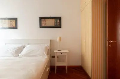a bedroom with a bed and a night stand with a lamp at Esquilino Lightsome Apartment in Rome