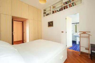 a bedroom with a white bed and a desk at Esquilino Lightsome Apartment in Rome