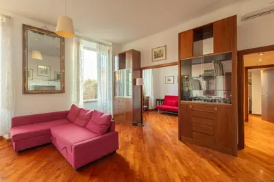 a living room with a pink couch and a tv at Esquilino Lightsome Apartment in Rome