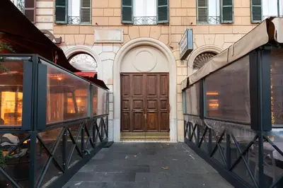 a building with a large wooden door on a street at Esquilino Lightsome Apartment in Rome