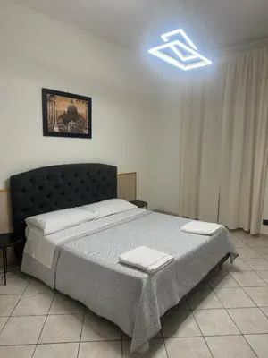 a bedroom with a bed with two towels on it at LarissaRooms in Rome