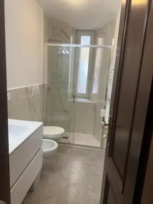 a bathroom with a shower and a toilet and a sink at LarissaRooms in Rome
