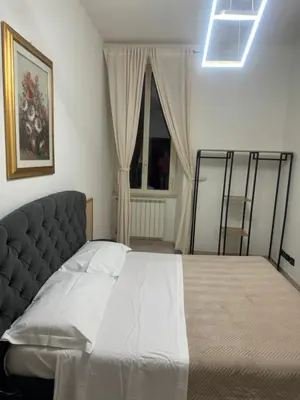 a bedroom with a bed and a window at LarissaRooms in Rome