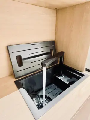 a kitchen sink with a faucet with water coming out at Luxury Nest Ponte Milvio in Rome