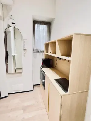 a kitchen with wooden cabinets and a refrigerator at Luxury Nest Ponte Milvio in Rome