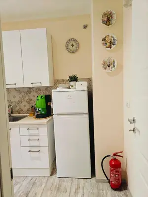 a kitchen with white cabinets and a white refrigerator at B&B A casa da Mami in Rome