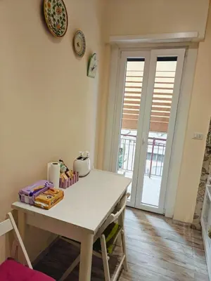 a dining room with a table and a clock on the wall at B&B A casa da Mami in Rome