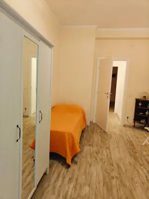 a bedroom with an orange bed and a wooden floor at B&B A casa da Mami in Rome