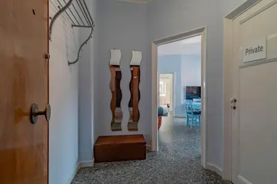 a hallway with a door leading to a room at Roma 1950 - Bright apartment in octagonal tower in Rome