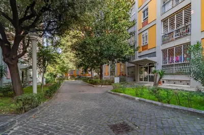 a cobblestone street in front of a building at Roma 1950 - Bright apartment in octagonal tower in Rome