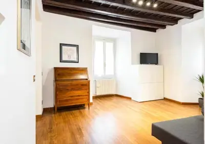 a living room with a dresser and a television at Piazza Farnese house in Rome